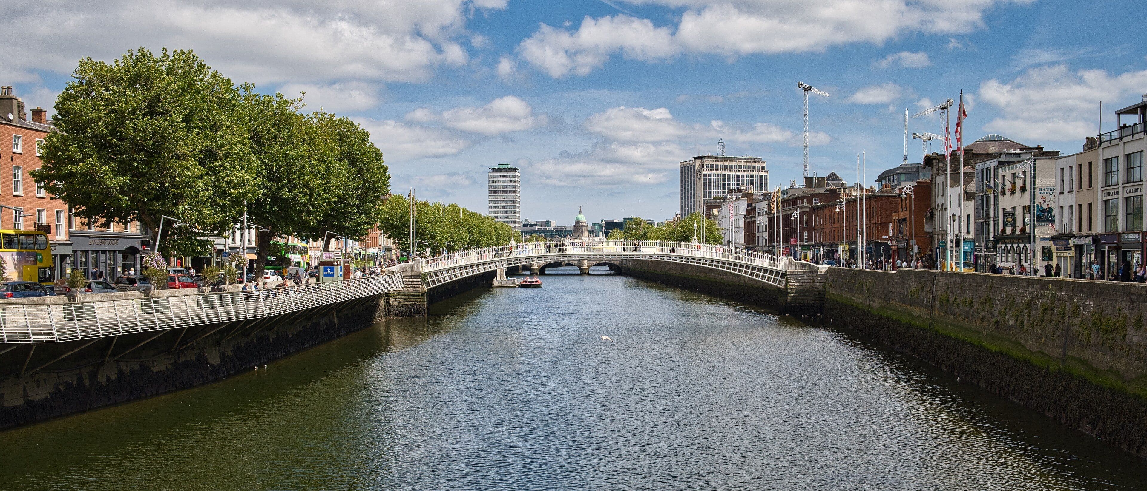 El río Liffey a su paso por el centro de Dublín, con el Ha'penny Bridge al fondo y los muelles a ambos lados
